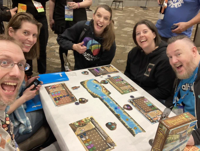 Shawn playing a game of river valley glassworks with happy folks