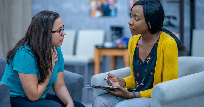 Image of two women talking, showing support.