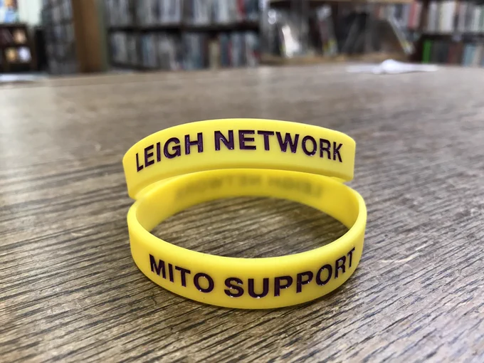 Yellow wristbands with purple writing Leigh network Mito support
