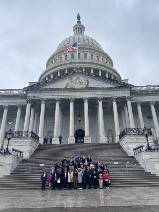 Large group of students standing in front of the US Capitol.