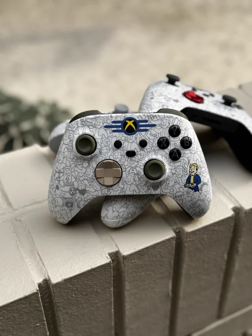 A stack of the Fallout Edition Xbox Wireless Controllers from Xbox Design Labs with the Pip-Boy version of the controller on top.
