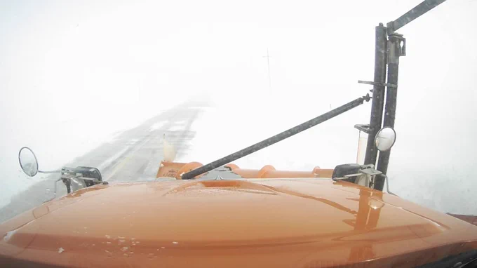 The view from one of the Iowa Department of Transportation's snowplows during a winter storm.