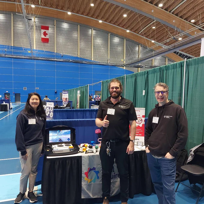 Kristina, Reed, and Chad at the Makers Making Change booth with an adaptive gaming set-up and 3D printed assistive technology.