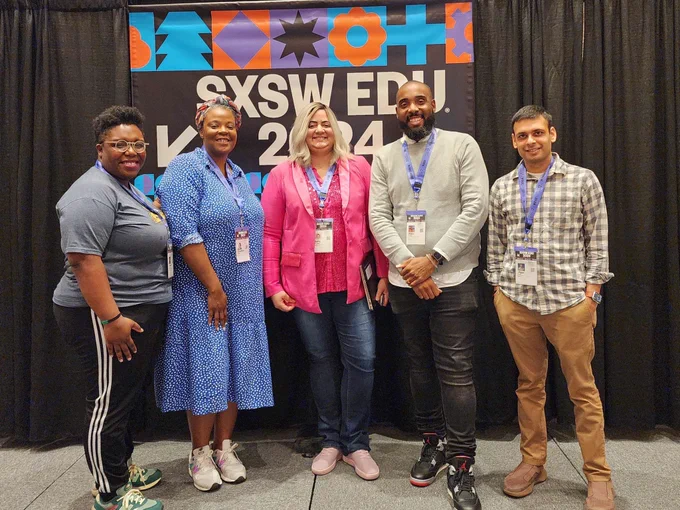 Five CSTA Equity Fellows pose on stage with a SXSW EDU 2024 banner.