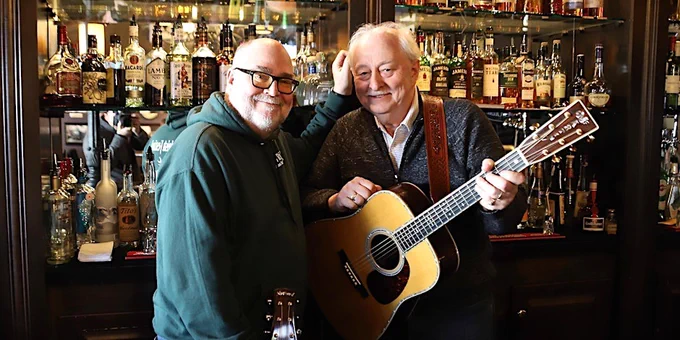 A photo of musicians Kevin Evans on the left and Brian Doherty on the right. Brian is holding an acoustic guitar. Learn more about their band, Evans & Doherty: https://www.evansanddoherty.com/