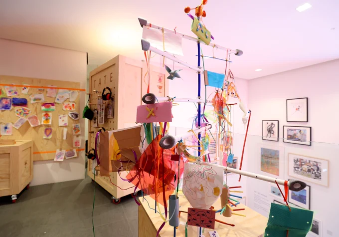 A wide photograph of the family space at Tate Liverpool   RIBA North showing a structure displaying the artwork created by families.