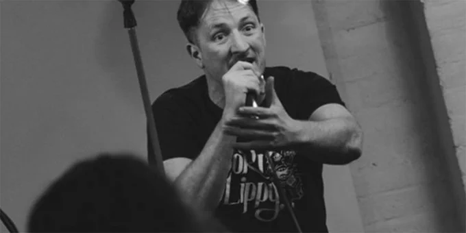 A poet on stage in The Geet Muckle Slam