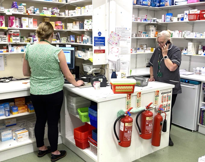 Staff working at Weldricks Pharmacy.