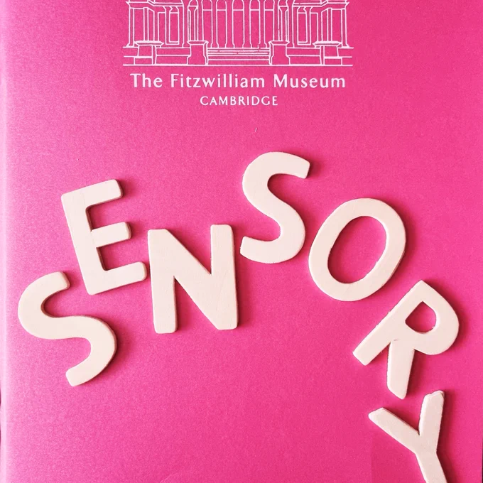 crop of bright pink sketchbook with white line drawing of the front of 'The Fitzwilliam Museum CAMBRIDGE' (with text below the drawing). Below the text, I placed wooden letters spelling 'SENSORY' on the sketchbook