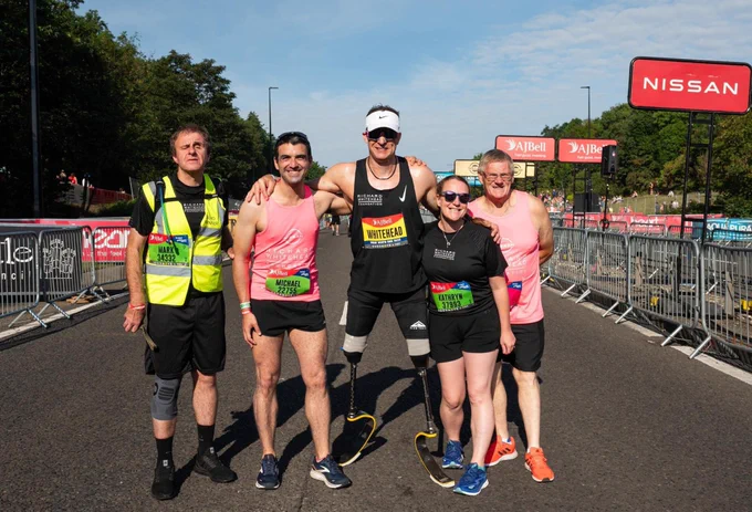 Richard Whitehead is standing in the middle of four runners at the start of the Great North Run.