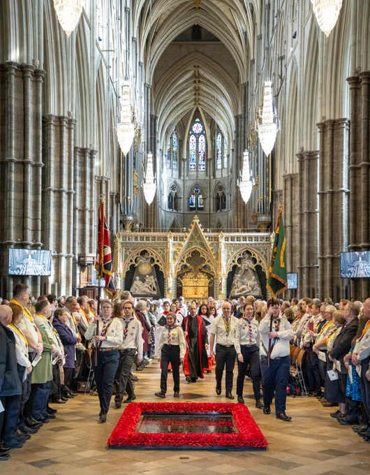 A group of Scouts carrying flags through Westminster Abbey