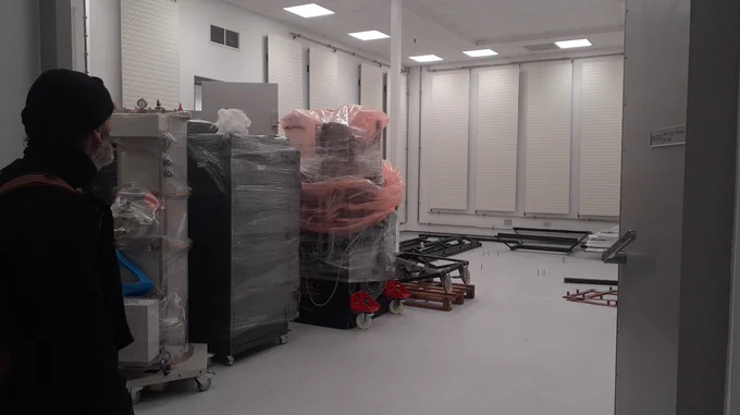 Rik looking in at the new room for the Titan, lots of parts, all packaged up…