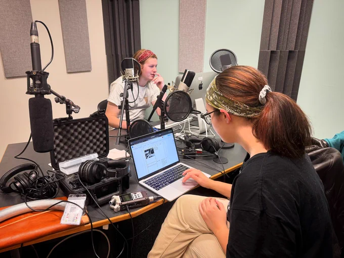 Students working in the podcast room on campus.