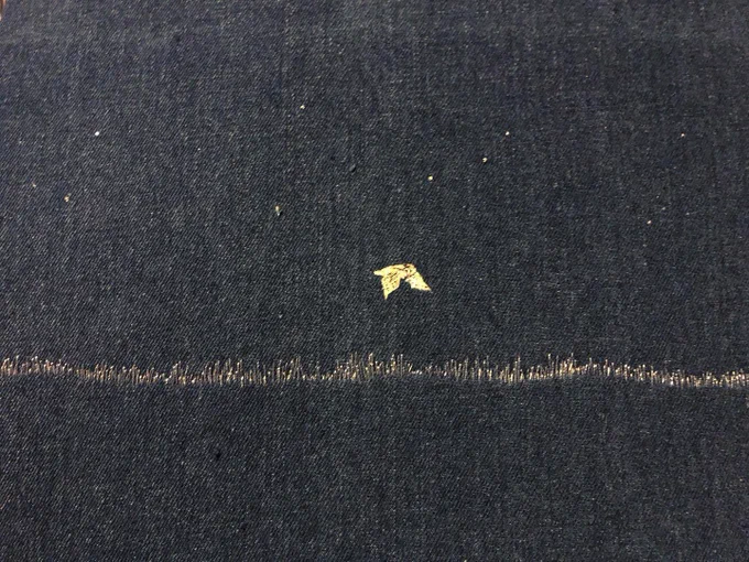 A embroidery barn owl over a silver thread pasture