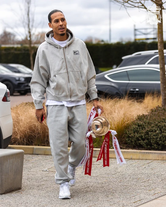 Virgil van Dijk arrives at the AXA Training Centre with the Carabao Cup in his left hand.