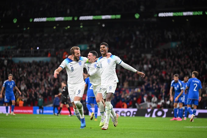 Marcus Rashford celebrates scoring to make it 2-1 with team mates Harry Kane and Phil Foden during the UEFA EURO 2024 European qualifier match between England and Italy at Wembley Stadium 