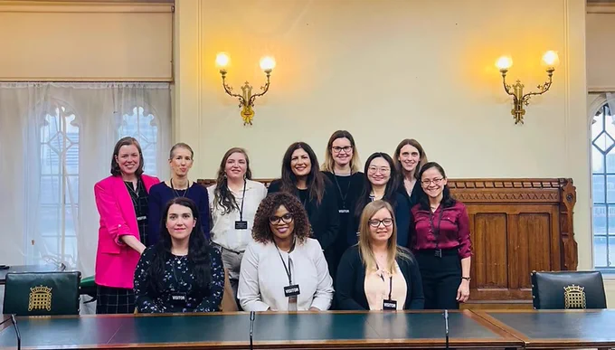 Group of 11 women sat in front of a table