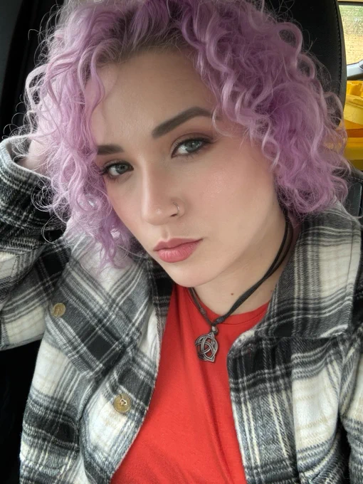 Community manager for copilot for Microsoft 365 tech community sarah Gilbert with purple curly hair and a flannel jacket