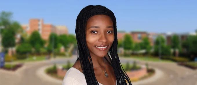Photo of Kaitlyn Taylor in front of a blurry photo of Jackson State University