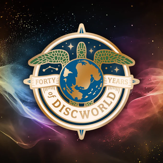 A stylised version of the Discworld as shown from above on a circular pin. Text reads, on overlaid banners, Forty Years of Discworld.