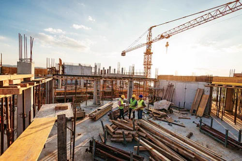 lumber and workers on construction site