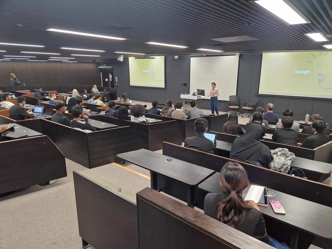 Image of Cathy addressing a large lecture theatre