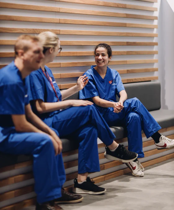 Nurses and technicians sat talking and smiling