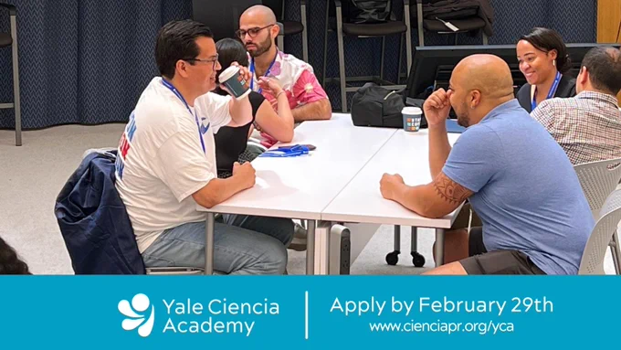 Five people sitting around a table interact during a workshop at the Yale School of Medicine. Text says: Yale Ciencia Academy. Apply by February 29th