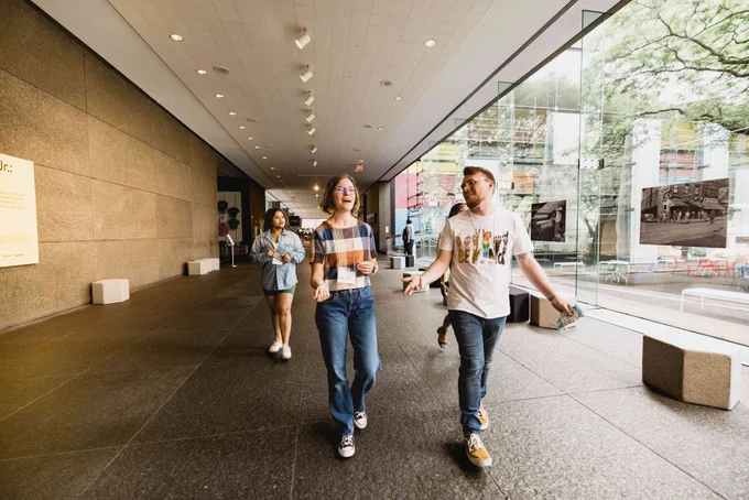 Group of Leadership Academy participants walk while through museum halls while conversing with each other