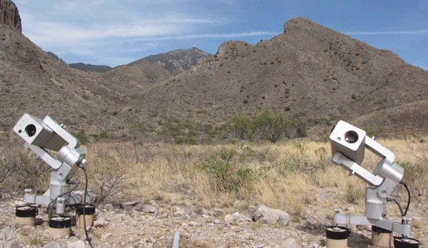 Two MicroObservatory Telescopes in front of mountains at Whipple Observatory. 