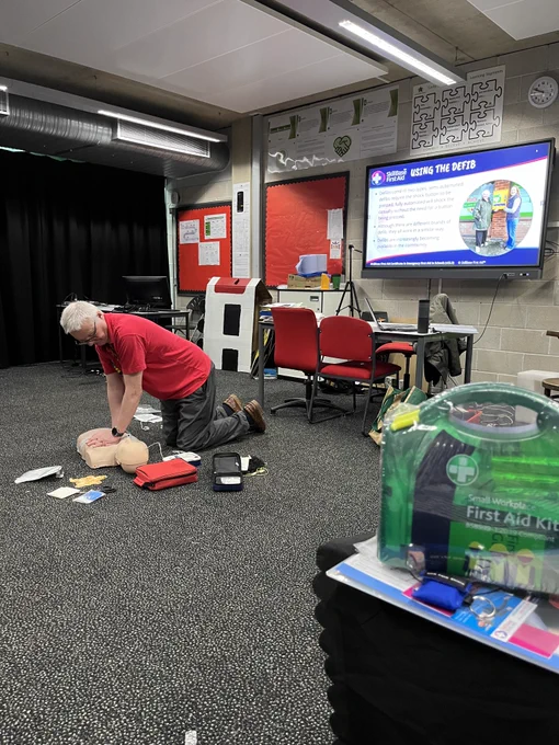 First aid instructor with CPR dummy.