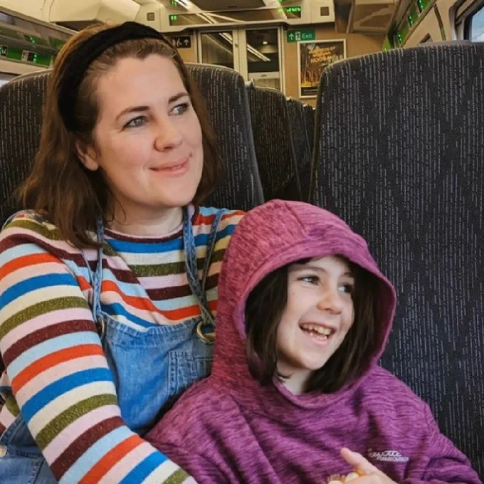 A mother and daughter on a train