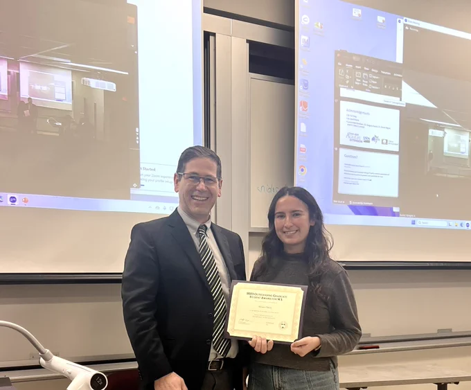 Master’s student Adriane Fifield receiving the 2023 Outstanding Master’s Graduate Student award by Department Head, Dr. Phillip Kaufman.