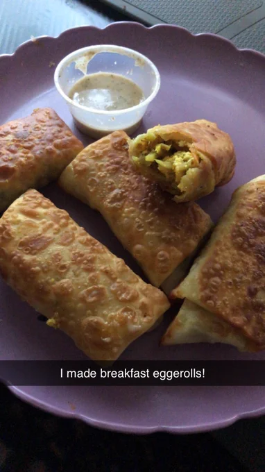Eggrolls on a purple plate with a cup of sauce on the side. Snapchat text says, "I made breakfast eggrolls!"
