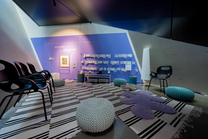 A purple wall overlooks chairs and comfy floor seating within the CORE