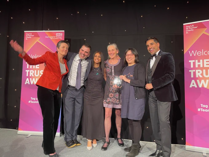 members of the PICU and STRS teams accept their award from Chief Nurse Avey Bhatia and apprentice nursing associate, Daniel Garcia