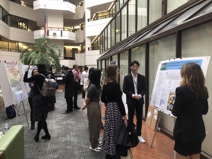 Poster session featuring scholars actively engaging in chats on research. Event is held in the ICC building on Georgetown’s main campus.
