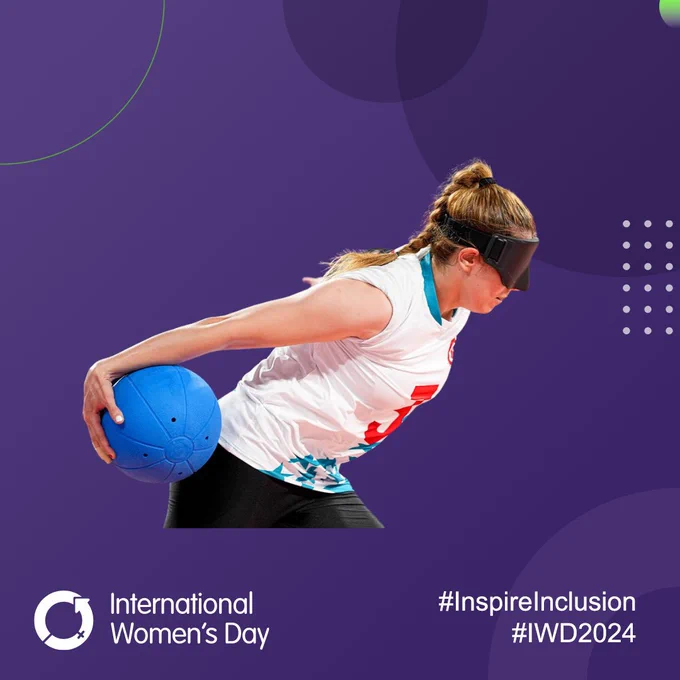 A female goalball player from Turkey holds the ball out behind her during a shot