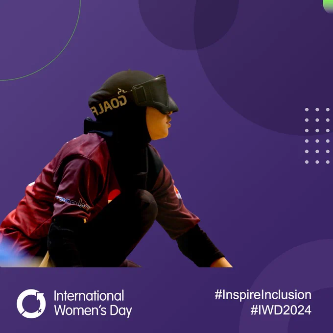 A female goalball player waits to hear the ball being thrown by the opposition