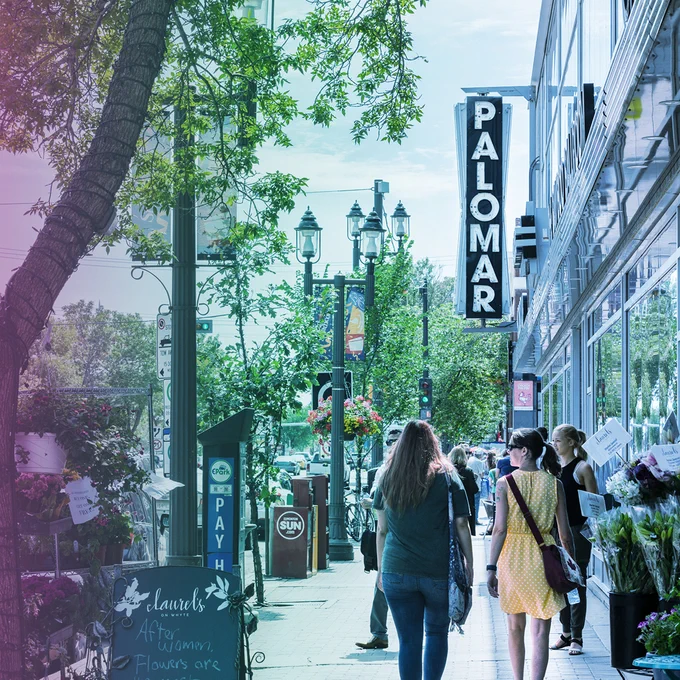 Two women walk down Whyte Avenue in Old Strathcona