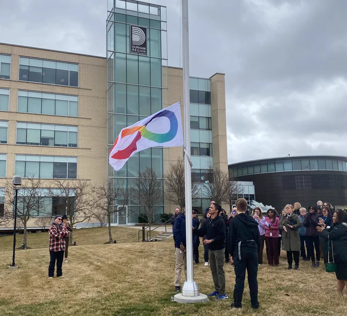 Students from Project Search Durham raising the Neurodiversity flag flying on a community flagpole at Regional Headquarters.