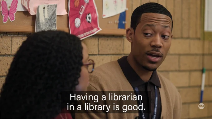 A still from a scene in the ABC sitcom "Abbott Elementary," where teacher Gregory Eddie (played by actor Tyler James Williams) says, "Having a librarian in a library is good."