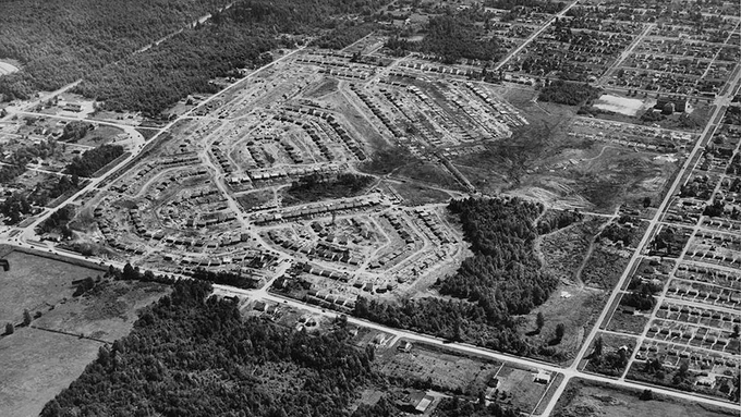 1948 aerial photo of Renfrew Heights community, Vancouver BC, designed  and developed by CMHC. Note the central school and radically different street network from the Vancouver grid that surrounds it on three sides. (Source: Library and Archives Canada, image PA-148474)