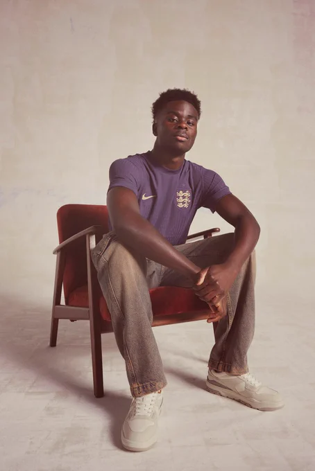 Bukayo Saka poses for a photo in the new England away kit.