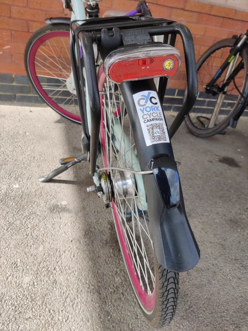 A York cycle campaign sticker on the rear mudguard of a parked bicycle