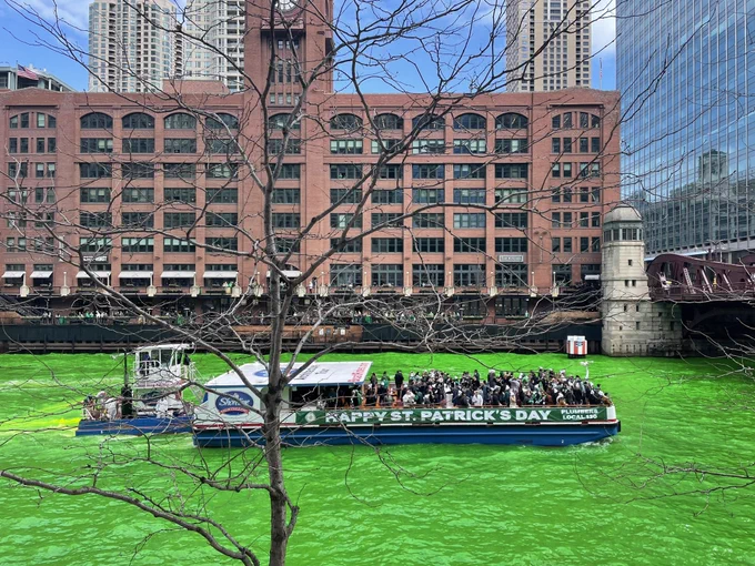 Chicago River, dyed fluorescent green. There’s a boat with a banner that says HAPPY ST PATRICKS DAY on it.