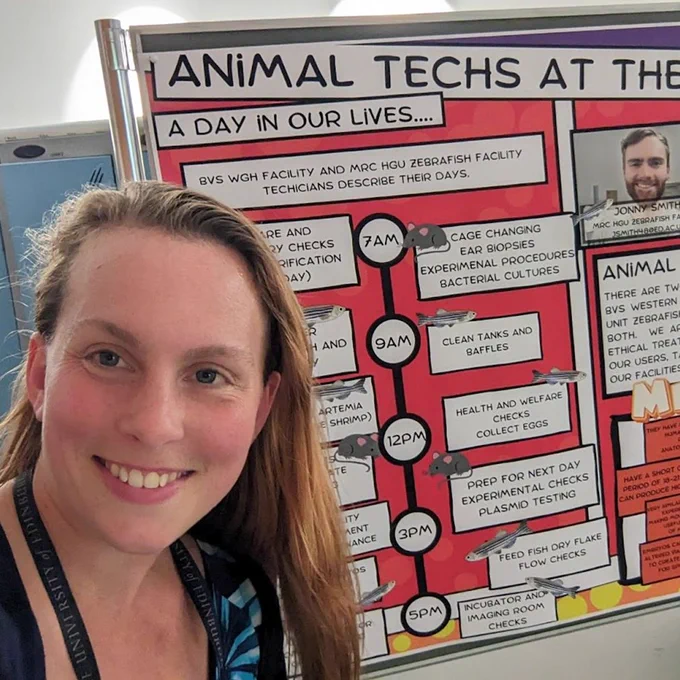 Charli in front of her poster on the life of Animal Techs.