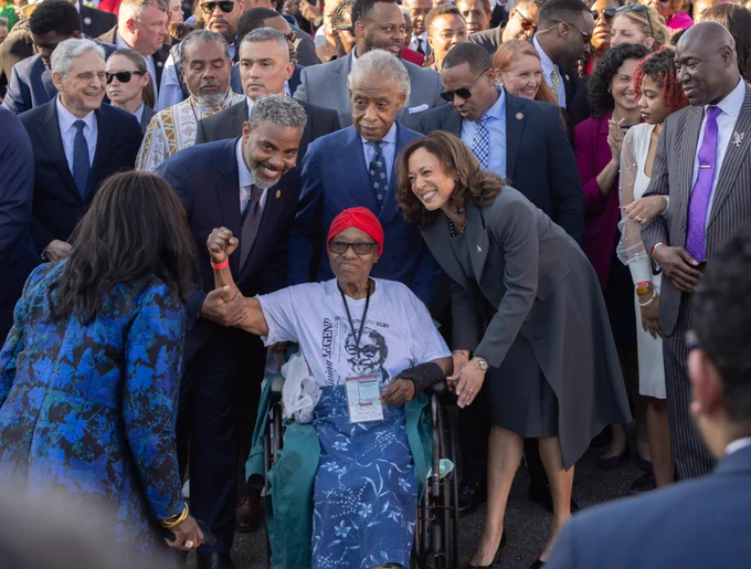 Vice President Harris stands arm-in-arm with civil rights and political leaders as they march across the Edmund Pettus Bridge. 