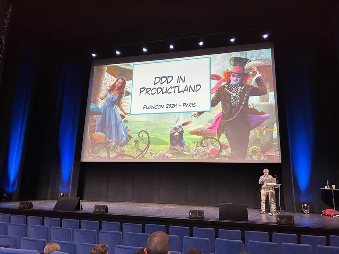 Alberto on stage with his presentation slide behind him.