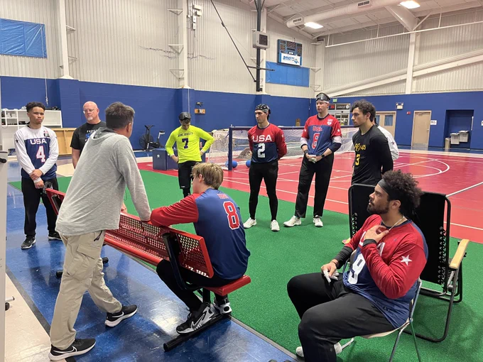 Players gather around to listen to Coach Keith Young as he discusses strategy.